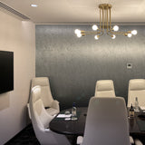 Large 900m Brass pendant lamp with 8 arms and exposed bulbs, shown in a hotel boardroom in Hobart Australia