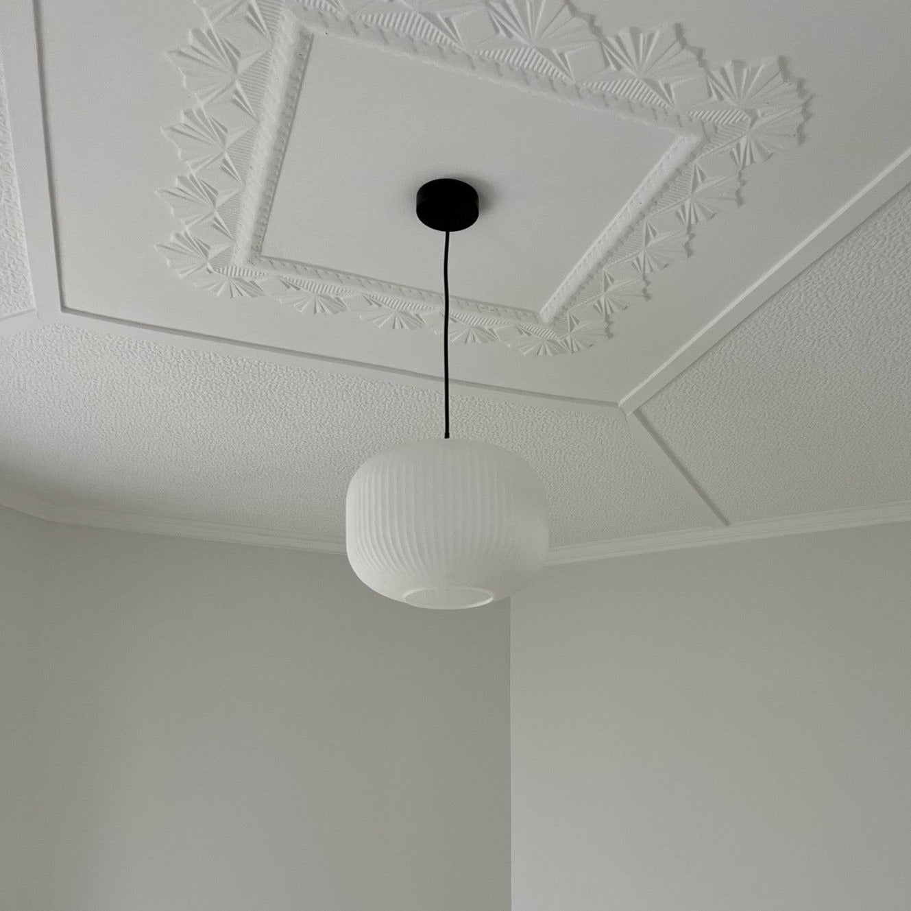 SMITH&SMITH Matte white ashter pendant suspended in bedroom showing art deco ceiling and pendant lamp