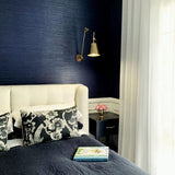 SMITH&SMITH Douglas Antique Brass Flexible Arm Sconce Wall Light in Bedroom with navy textured wall paper and cream bed head. insta